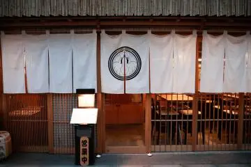White noren curtain and wooden lattice facade