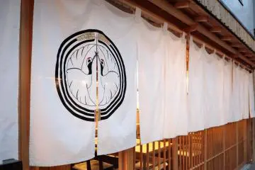 White noren curtain and wooden lattice facade