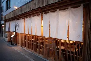 White noren curtain and wooden lattice facade