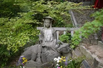 Interesting statue of a man riding an Ox next to Inari Jinja.