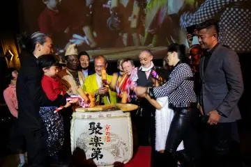The mayor of Kyoto, Kyotographie founders Lucille and Yusuke, and all main exhibition artists performing a 'kagami biraki', involving breaking a sake barrel to signify the start of Kyotographie