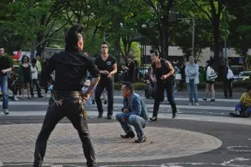 The dancer in denim is taking a break from his rather energetic dance moves