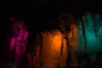 Multi-coloured lights illuminate the cavern, giving it a magical atmosphere