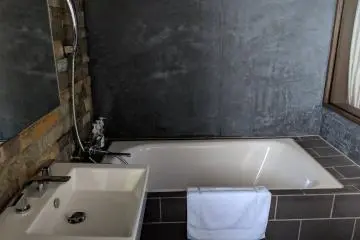 The bathroom also has the trendy, warehouse apartment feel.