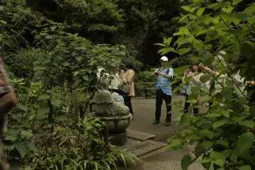 Visitors photographing a god