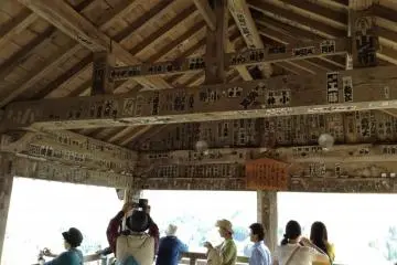 Inside the viewing platform you see what look like stickers. These are old postings from villagers that made the long trek from their villages before modern transportation systems.