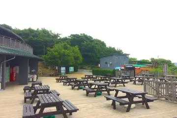 Picnic tables and shops located at entrance 