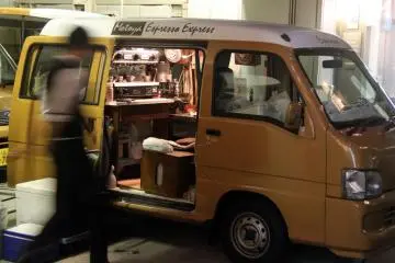 A mobile coffee van with quaint coffee making equipment. It takes the term 'to-go/takeaway' to a whole new level.