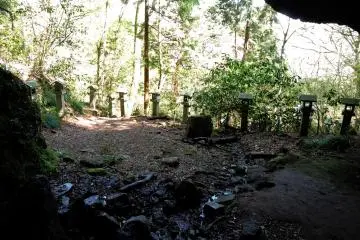 A row of stone lanterns outside the cave