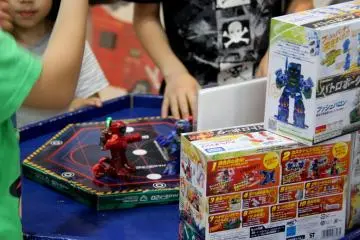 Zealous movements of the children’s hands that control the robots movements in hopes of winning each other.