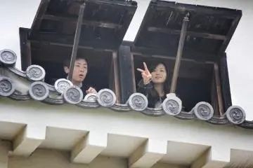 He is stunned by the view, while she mugs for the camera