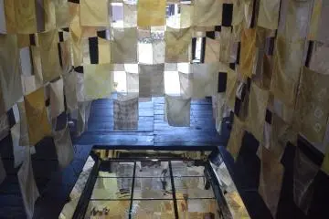 Traditional textiles and mirrors make up this artwork