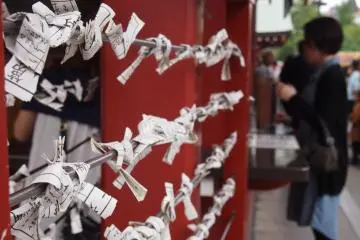 <p>Omikuji in stick form can found in the main hall and outside it. Think of your question as you shake the metal container provided until a labeled stick falls out, and then draw out the paper from a box that has the corresponding number on the stick.</p>