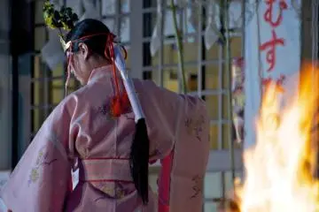 Full time "miko" shrine maidens perform a more austere dance