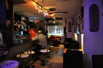 The owner Julien behind the bar