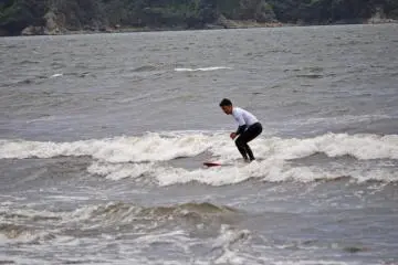 Surfers making do with the small waves