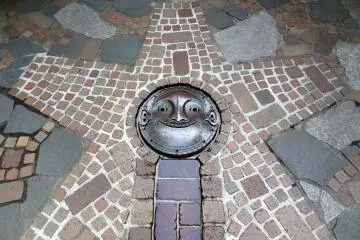 <p>Don't forget to look down when walking throughout the museum grounds. Here's a smiling face strategically placed at the end of the tiled stream of fresh water from the hand pump well</p>