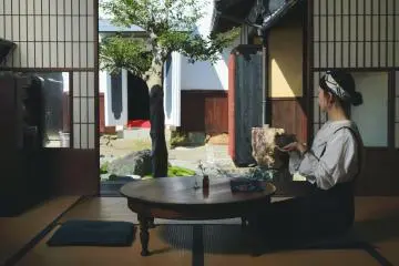 Sipping tea by an open shoji door