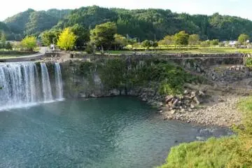 View of the falls and the suspension bridge from the eastern path. In between there are the stairs which lead you down to the water.