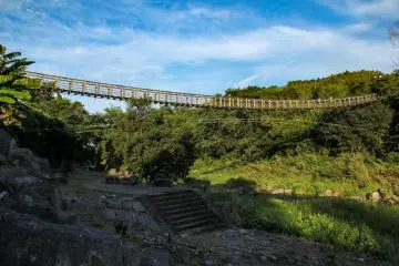 Instead of going back up the stairs you can follow this path under the suspension bridge