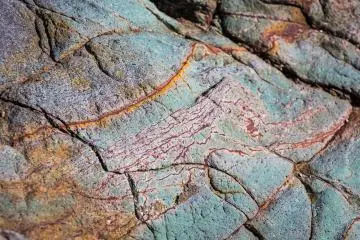 A rainbow of minerals appear on closer inspection of the rocky cliffs