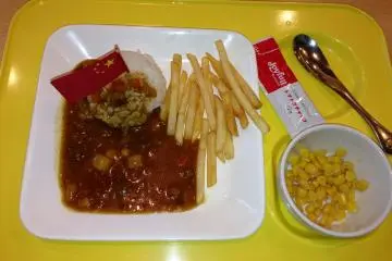 <p>A childrens curry plate with a Chinese flag indescriminately placed into the rice</p>