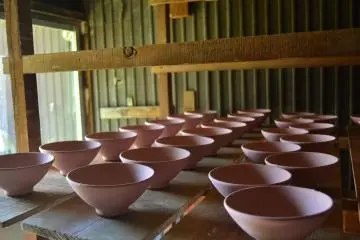 Raw pink colored teabowls awaiting firing.