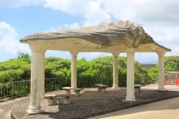 Relaxation is taking a break underneath an oyster shaped pavillion along the beach