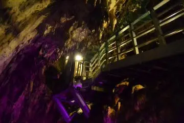 Bridge that passes you to the other side of the cave, illuminated with various colored lighting.