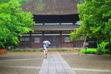 The Genji family crest is visible atop the thatched roof of Chosho-ji