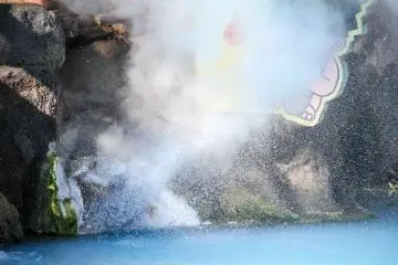 A close up of the front of the steam vent shot in high shutter speed. You can see lots of water being sprout together with the steam