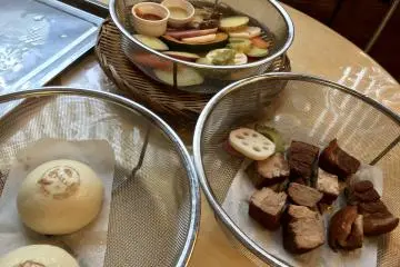 Pork belly, nikuman (pork buns) and a host of veggies, steamed to perfection! (Photo: Kim B)