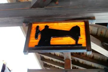 Some shops have their own old styled signboard; this is a sewing machine indicating a clothing store