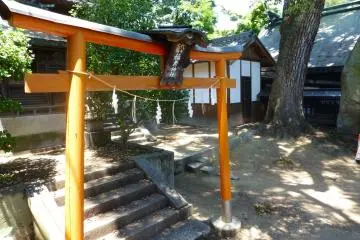 A bright orange torii gate signifies sacred ground