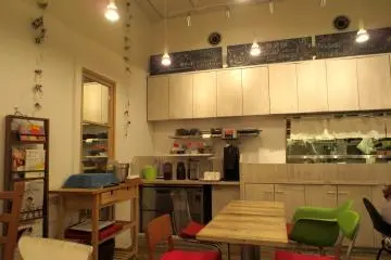 The drink bar, the kitchen, and the mismatched chairs