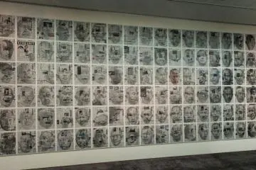 <p>The room is filled with drawings of Yoshimura's face on newspapers.</p>