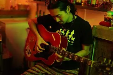 Bar man Teppei whips out the guitar