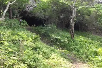 <p>A short side path takes you to a small cave with a miniature shrine inside</p>