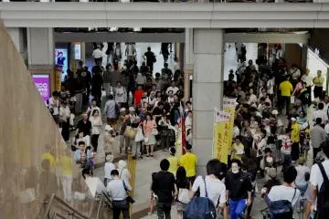 People gathering around what seemed to be a public political rally