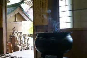 Early morning incense masks the smell of the rain
