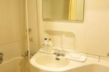 Sparkling white toilet coupled with a bathtub