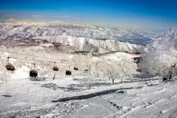 As the ski lift whisks you up to the top, you begin to the see the vast mountain ranges which dominate this region