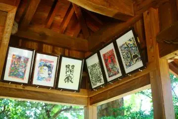There are traditional Japanese paintings hung inside the shrine's roof