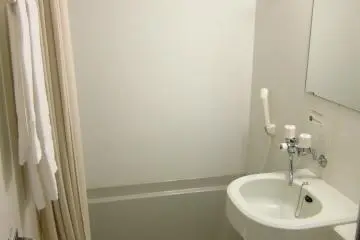 Sparking White Bathroom with Bathtub at Hotel Grantia Akita Spa Resort