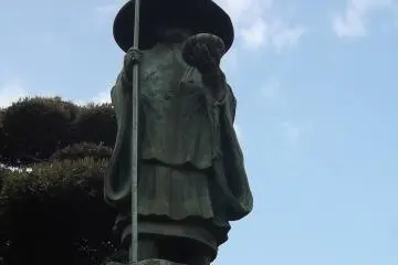 This pilgrim looks down from a high pedestal