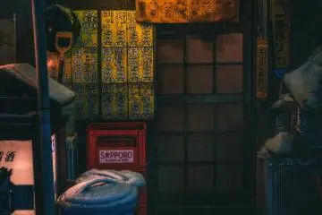 A small Japanese pub in Aomori City lit up on a snowy night