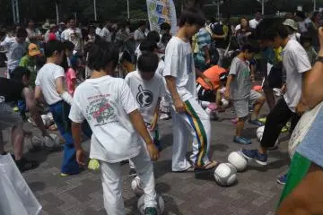 Kids gather around for a soccer lesson