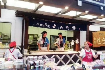 Walking through the "shoutengai" store street,  traditional candy  makers cut away rhysimically as if they were doing a coordinated dance! (Photo: Erika Clark )