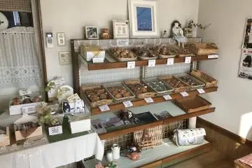 There are baked goods like muffins and cookies lining one of the walls