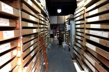 Shelves lined with stacks of Ise washi stencils 